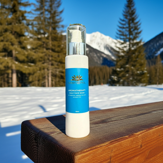 Skincare bottle with blue label on a wooden surface with a snowy mountain background