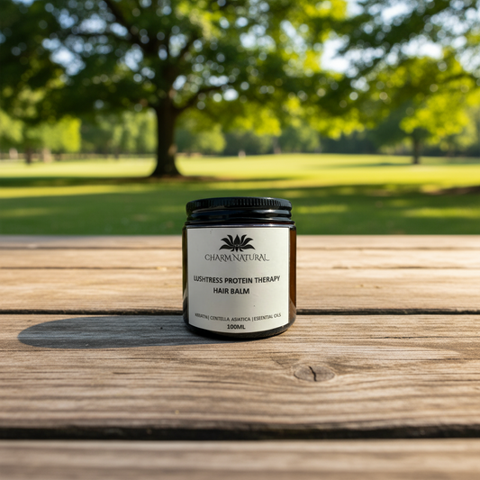 Jar of Charm Natural hair balm on a wooden surface with a park background